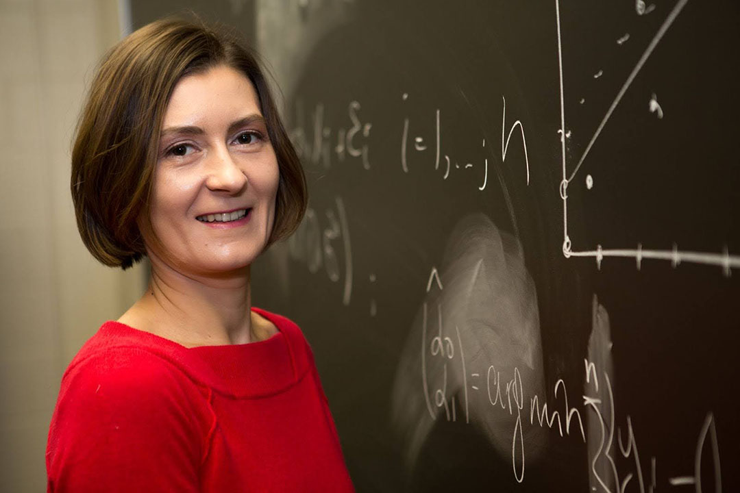 Tatiyana Apanasovich in front of a chalkboard