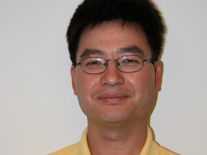 Statistics PhD Program Director, Feifang Hu, in a yellow shirt